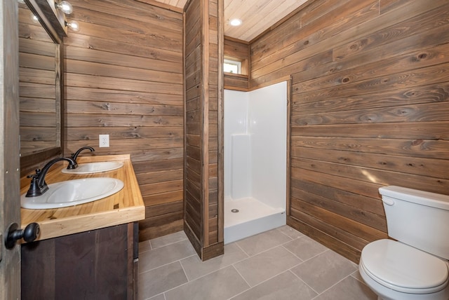 bathroom with wood walls, a shower, tile patterned flooring, vanity, and toilet