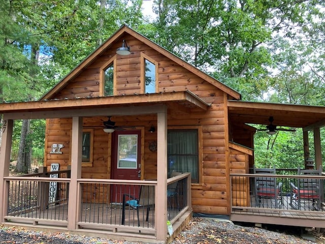 rear view of property featuring ceiling fan and covered porch