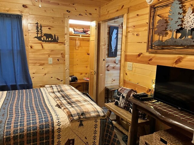 bedroom featuring wood walls and a closet