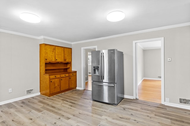 kitchen with light wood-type flooring, crown molding, and stainless steel refrigerator with ice dispenser