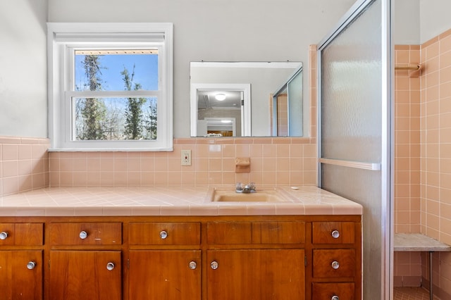 bathroom featuring vanity, tasteful backsplash, and walk in shower