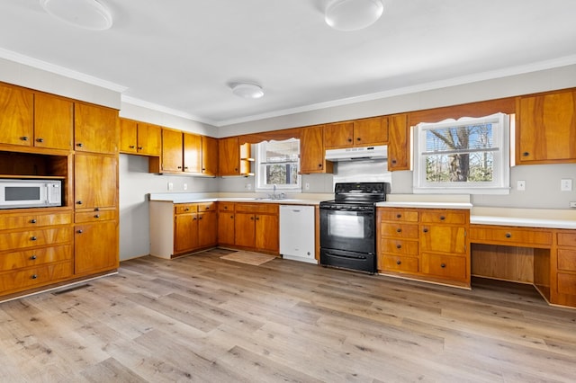 kitchen with white appliances, crown molding, light hardwood / wood-style floors, and built in desk