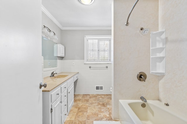 bathroom with tile walls, ornamental molding, vanity, and tub / shower combination