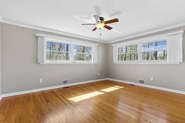 unfurnished room with ceiling fan, plenty of natural light, crown molding, and light hardwood / wood-style flooring