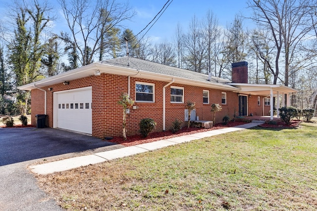 view of side of home featuring a yard and a garage