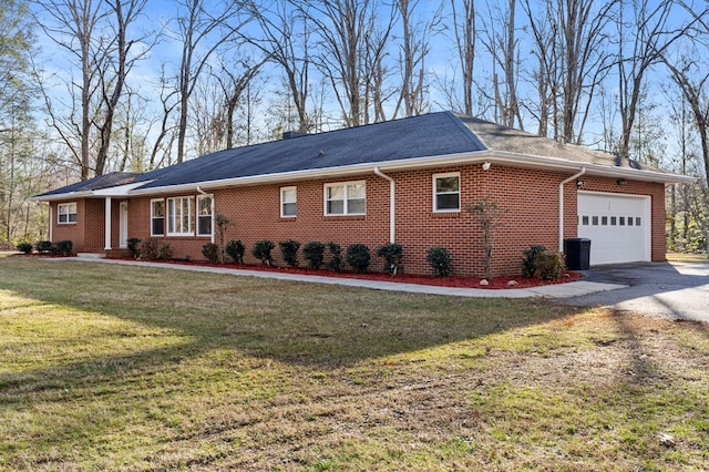 view of side of property with a garage and a lawn