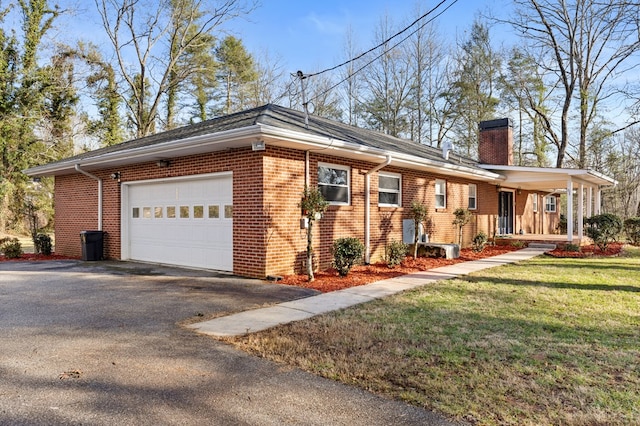 view of property exterior with covered porch, a garage, and a lawn