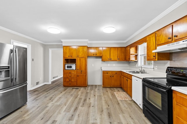 kitchen with sink, ornamental molding, white appliances, and light wood-type flooring