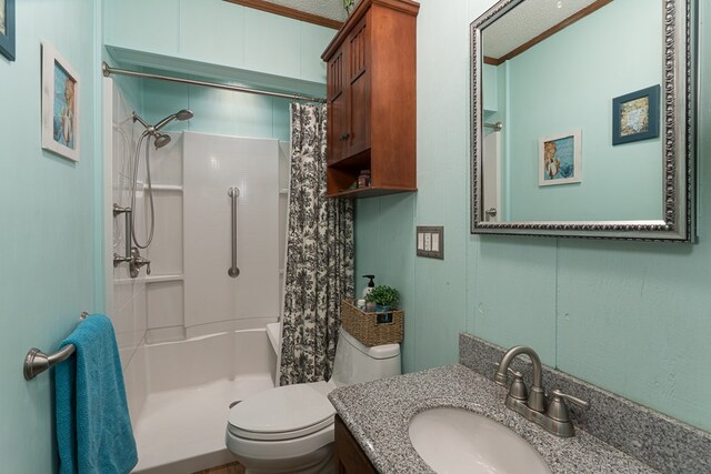 bathroom featuring ornamental molding, vanity, and toilet