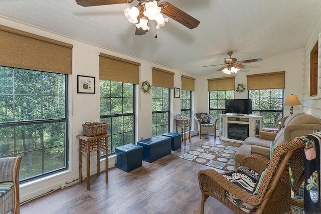 living room with dark wood-type flooring, a wealth of natural light, and ceiling fan