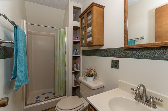 bathroom with vanity, toilet, walk in shower, and a textured ceiling