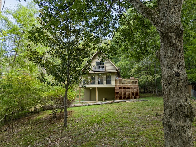 exterior space featuring a balcony and a lawn