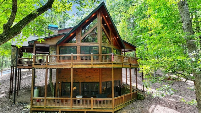 rear view of property with a sunroom