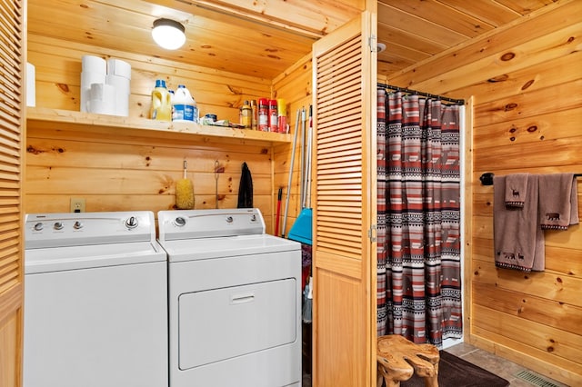 laundry area featuring washer and dryer, wood walls, and wood ceiling