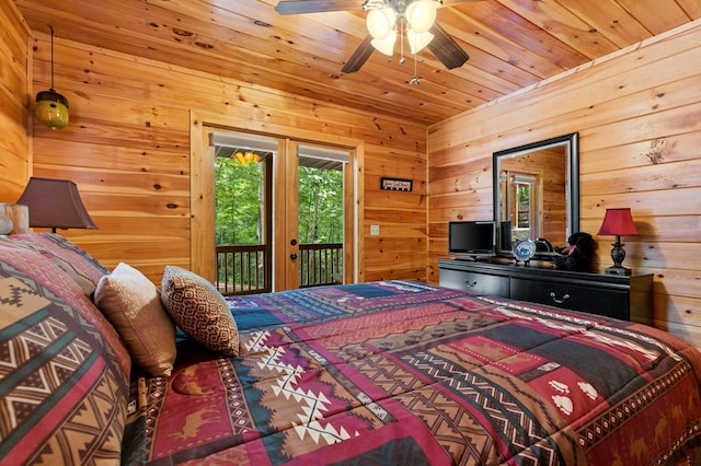 bedroom with wooden walls, ceiling fan, access to outside, and wood ceiling