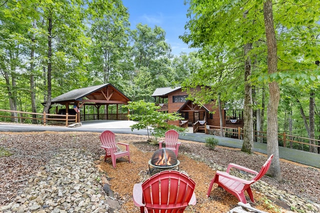 view of community with an outdoor fire pit and a gazebo