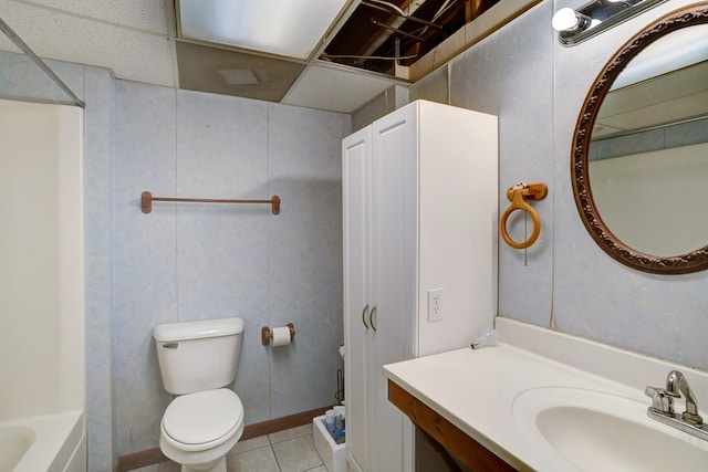 full bathroom with vanity, toilet, tile patterned floors, and a drop ceiling