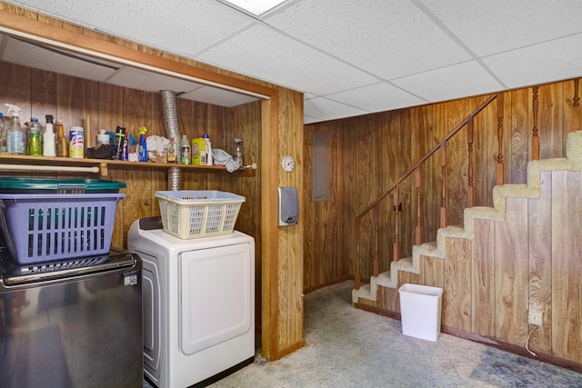 laundry room with wood walls