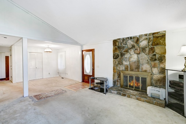 unfurnished living room featuring a fireplace, carpet, and vaulted ceiling