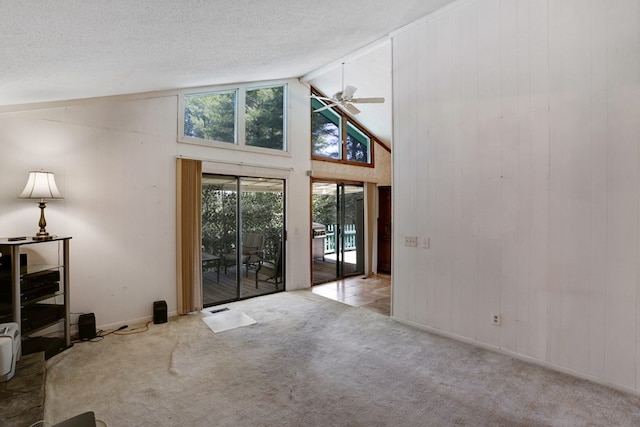 interior space with a textured ceiling, ceiling fan, and high vaulted ceiling