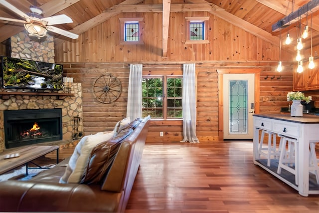 living room featuring a wealth of natural light, a stone fireplace, wood finished floors, high vaulted ceiling, and wooden ceiling