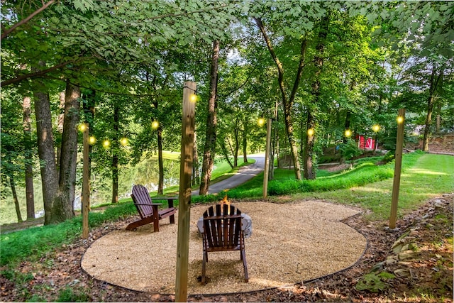 view of home's community featuring a fire pit and a yard