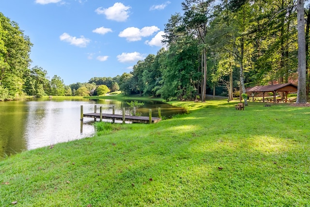 dock area featuring a gazebo, a water view, and a yard