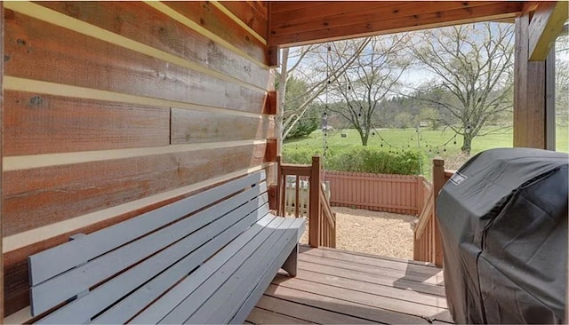 deck with area for grilling and fence