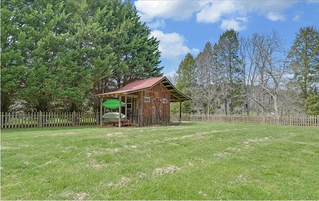 view of yard with fence and an outdoor structure