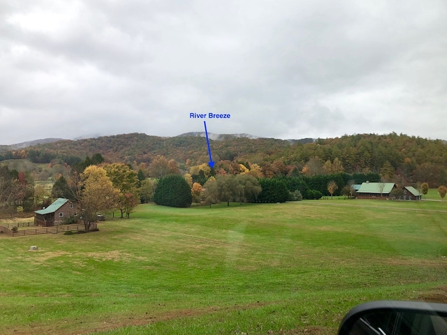 property view of mountains featuring a forest view