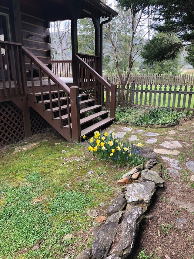 wooden terrace featuring stairs and fence