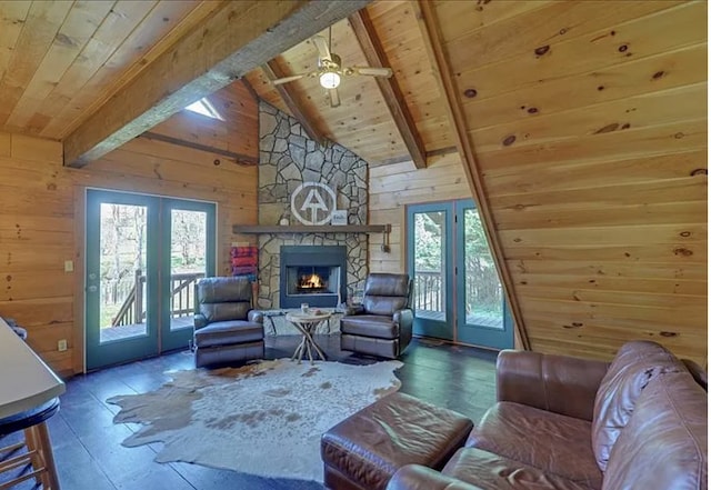 living room featuring wooden walls, a wealth of natural light, and wood ceiling