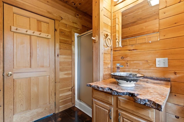 full bathroom featuring a stall shower, wooden walls, vanity, and wood ceiling