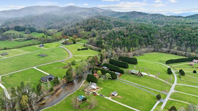 drone / aerial view with a rural view, a forest view, and a mountain view