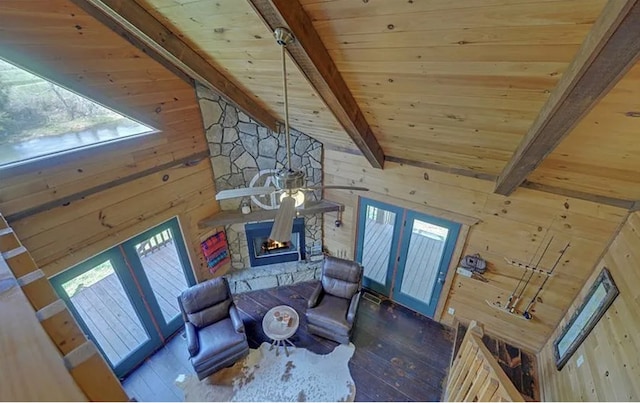 living area with wood walls, french doors, and wooden ceiling
