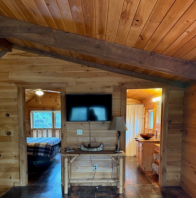 bedroom featuring wooden ceiling, wooden walls, lofted ceiling with beams, and multiple windows