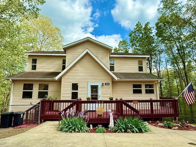 rear view of property featuring a wooden deck