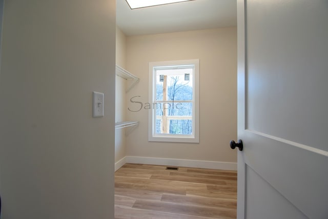 walk in closet featuring light hardwood / wood-style floors