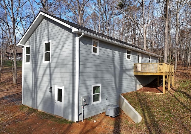 view of side of property featuring a deck and central air condition unit