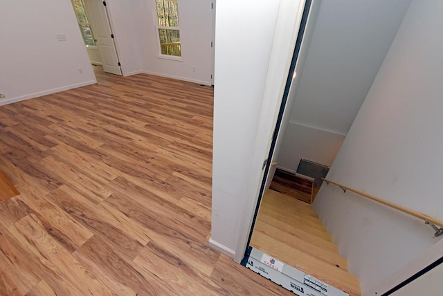 stairway with hardwood / wood-style flooring