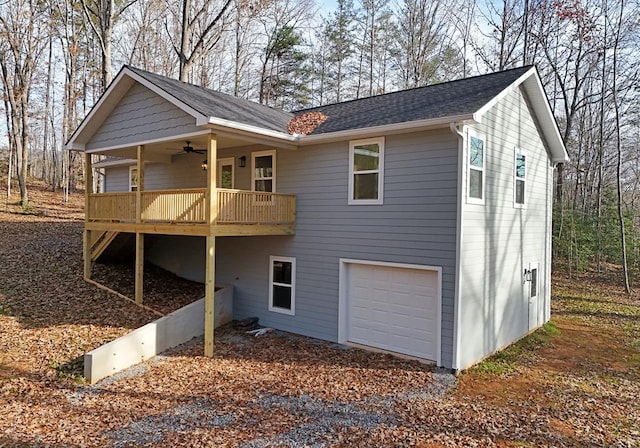 exterior space with ceiling fan and a garage