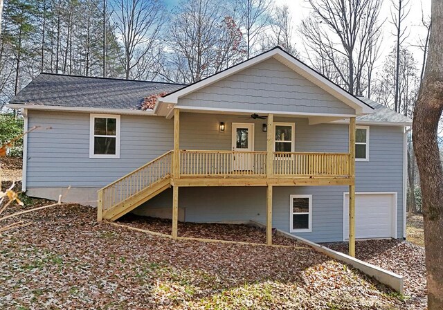 rear view of property featuring a porch, a garage, and ceiling fan