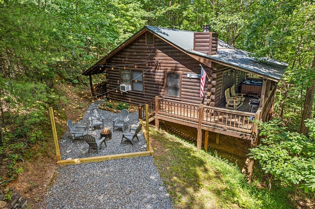 57 Coffee Pot Dr, Blue Ridge, GA 30513 - rear view of property featuring log siding, a deck, an outdoor fire pit, a chimney, and a patio