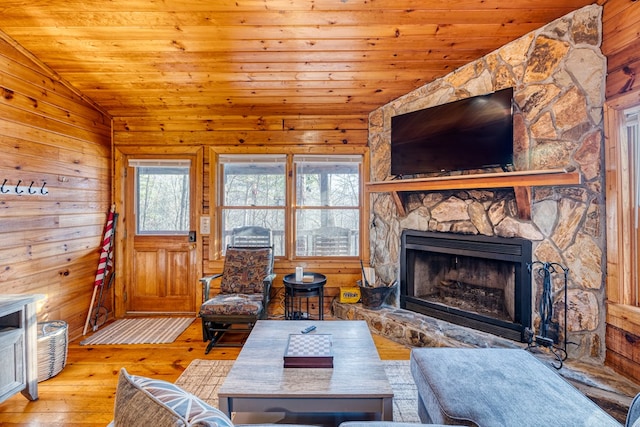 57 Coffee Pot Dr, Blue Ridge, GA 30513 - living room featuring a stone fireplace, hardwood / wood-style flooring, lofted ceiling, wooden walls, and wooden ceiling