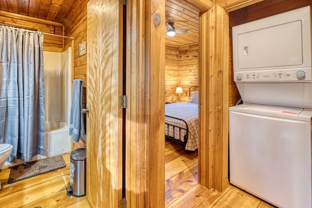 57 Coffee Pot Dr, Blue Ridge, GA 30513 - clothes washing area featuring stacked washer / drying machine, wooden walls, wooden ceiling, and hardwood / wood-style floors