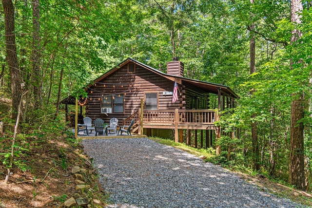 57 Coffee Pot Dr, Blue Ridge, GA 30513 - view of front of property featuring a chimney, log exterior, a wooden deck, and a view of trees