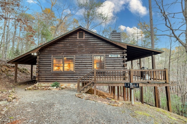 57 Coffee Pot Dr, Blue Ridge, GA 30513 - view of home's exterior with log siding, a chimney, and a porch
