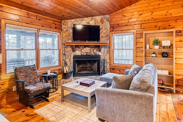 57 Coffee Pot Dr, Blue Ridge, GA 30513 - living area featuring lofted ceiling, wood ceiling, hardwood / wood-style flooring, a stone fireplace, and wood walls