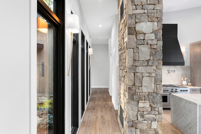 hallway with light hardwood / wood-style flooring