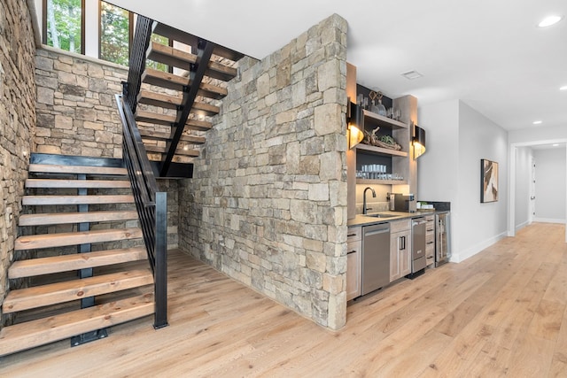 interior space with hardwood / wood-style flooring, dishwasher, sink, and wine cooler